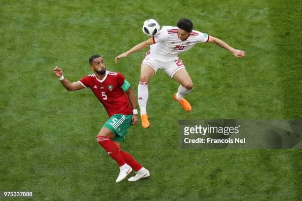 Sardar Azmoun of Iran wins a header from Mehdi Benatia of Morocco during the 2018 FIFA World Cup Russia group B match between Morocco and Iran at...