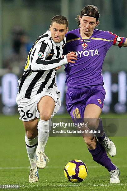 Riccardo Montolivo of ACF Fiorentina battles for the ball with Antonio Candreva of Juventus FC during the Serie A match between at ACF Fiorentina and...