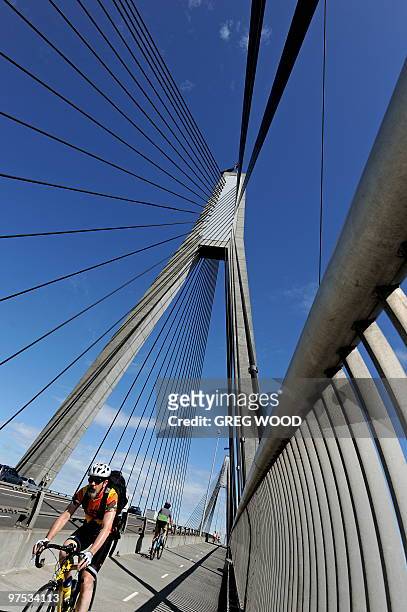 Cyclist rides over the Anzac Bridge in Sydney on March 8 the longest concrete cable-stayed span bridge in Australia. AFP PHOTO/GREG WOOD