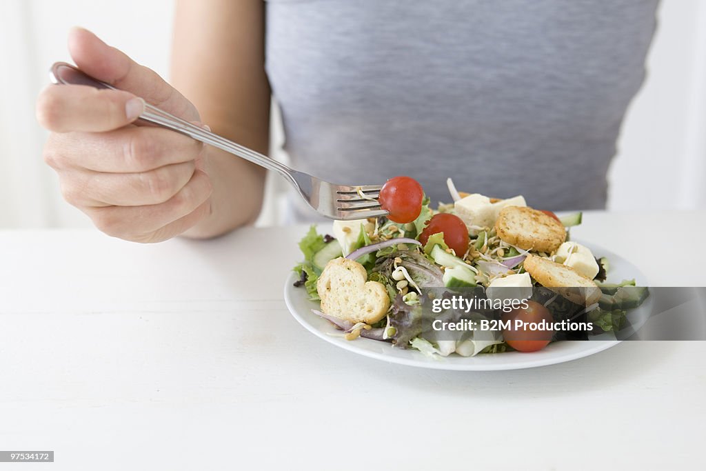 Woman eating salad