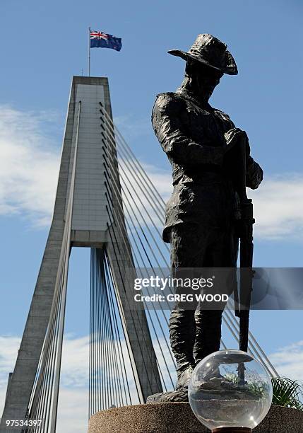 Bronze statue of an Australian First World War digger bowed in silent reflection stands at one end of the Anzac Bridge in Sydney on March 8 the...