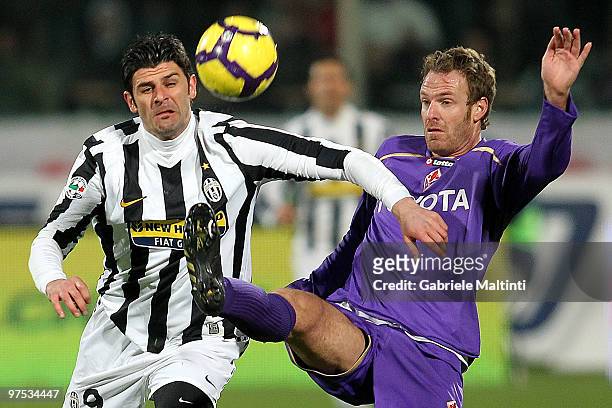 Cesare Natali of ACF Fiorentina battles for the ball with Vincenzo Iaquinta of Juventus FC during the Serie A match between at ACF Fiorentina and...