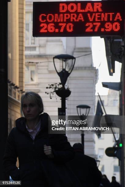 Currency exchange values are seen in the buy-sell board of a bureau de change in the financial district of Buenos Aires on June 15, 2018. -...