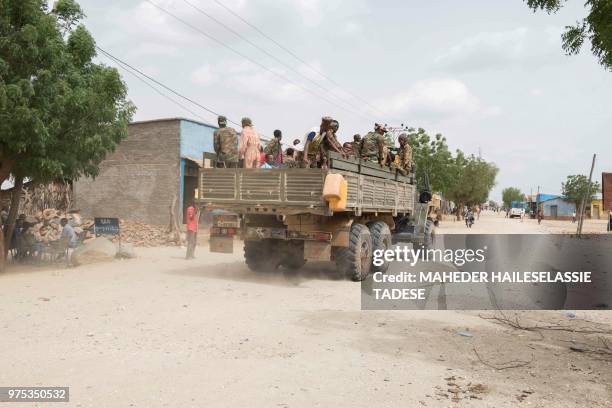 Ethiopian troops ride on a the back of a miltiray truck in Badme a disputed town on the border between Ethiopia and Eritrea on June 14, 2018. - If...