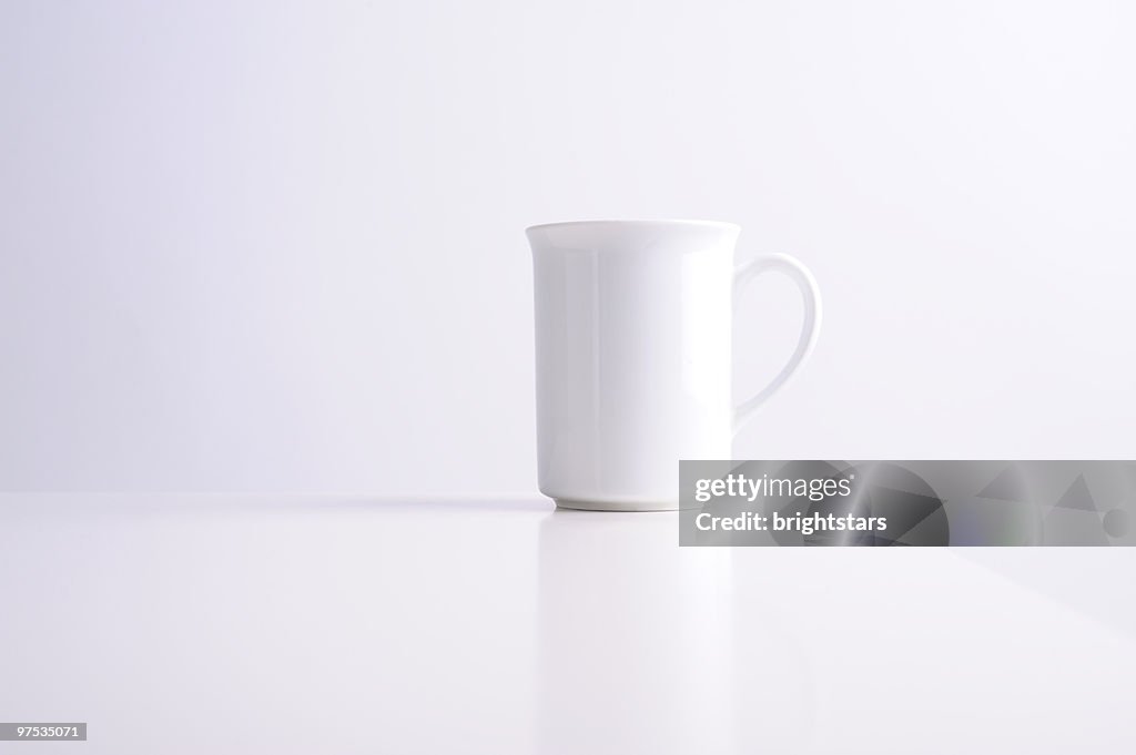 White mug on white table