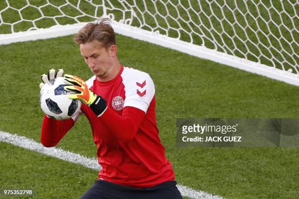 Denmark's goalkeeper Frederik Ronnow catches the ball as he takes part in a training session of Denmark's national football team at the Mordovia...