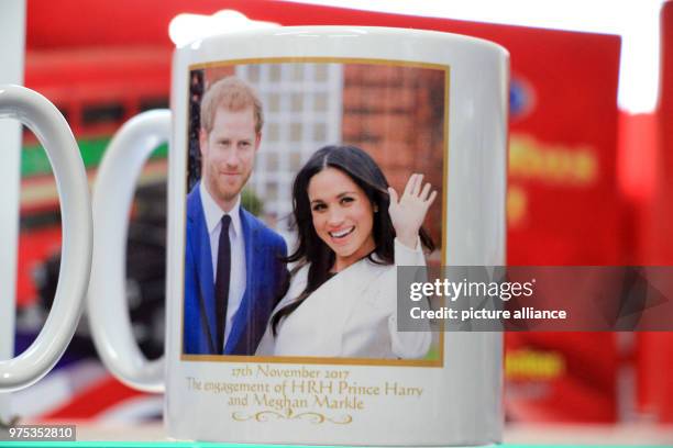 Febuary 2018, Great Britain, Windsor: A mug with the image of Prince Harry and Meghan Markle is offered for sale in a souvernir shop. Tourists from...