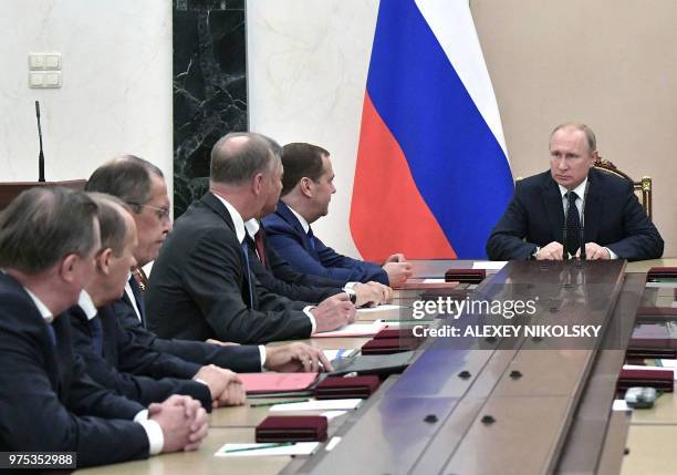 Russian President Vladimir Putin , Russian Foreign Minister Sergei Lavrov and Russian Prime Minister Dmitry Medvedev attend a meeting with permanent...