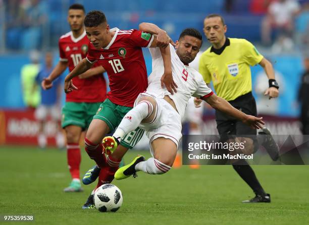 Amine Harit of Morocco is tackled by Omid Ebrahimi of Iran during the 2018 FIFA World Cup Russia group B match between Morocco and Iran at Saint...