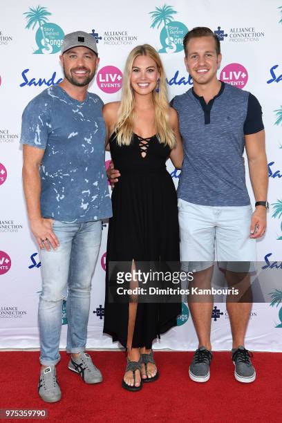 Cody Alan and fiancé Trea Smith pose with Marley Sheerwood on the red carpet at Sandals Royal Bahamian during CMT Story Behind the Songs LIV+ Weekend...