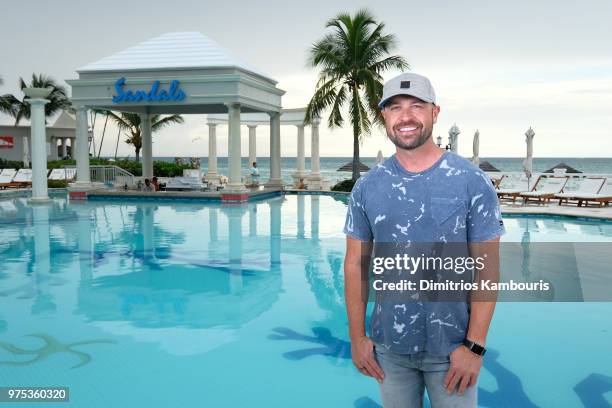 Host Cody Alan poses at Sandals Royal Bahamian during CMT Story Behind the Songs LIV+ Weekend with Jason Aldean and Dustin Lynch on June 14, 2018 in...