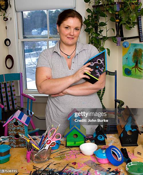 woman painting decorative birdhouses - natick stock pictures, royalty-free photos & images