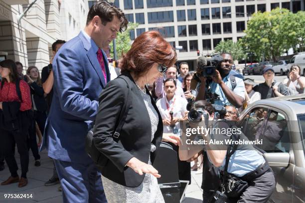 Kathleen Manafort, wife to former Trump campaign manager Paul Manafort is helped to a waiting car after her husband's bail was revoked during a...