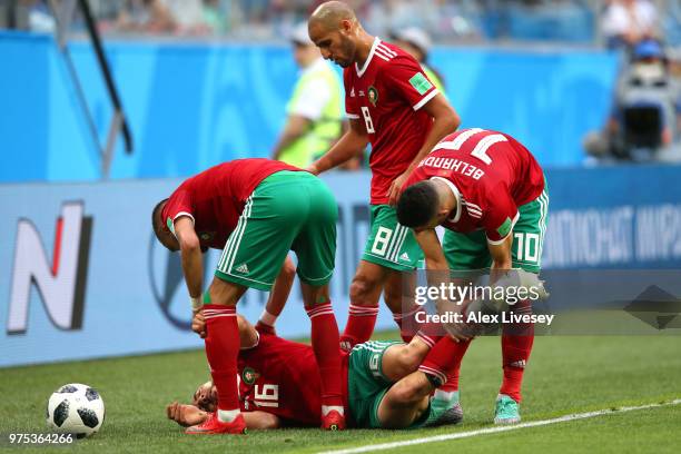 Noureddine Amrabat of Morocco's teammates check on him as he collides with and Iran player causing him to go down injuerd during the 2018 FIFA World...