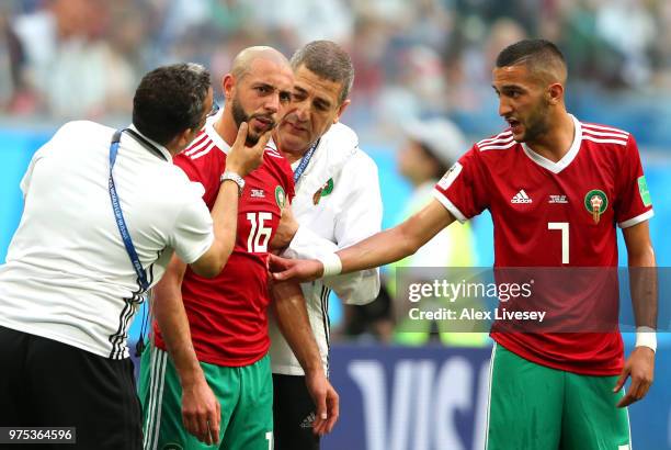 Noureddine Amrabat of Morocco reacts as he recieves treatment from the medical staff during the 2018 FIFA World Cup Russia group B match between...