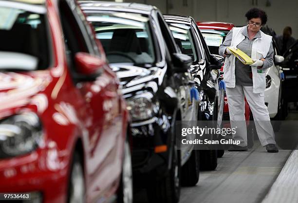 Worker inspects finsihed Volkswagen Golf cars at the end of the assembly line at the VW factory on March 8, 2010 in Wolfsburg, Germany. Volkswagen...