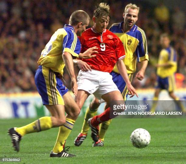 Denmark's Jon Dahl Tomasson is chased by Sweden's Olof Mellberg and Haakon Mild, during the friendly match between Denmark and Sweden at Parken...