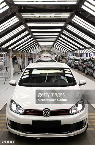 Finished Volkswagen Golf GTI prepares to drive off the assembly line at the VW factory on March 8, 2010 in Wolfsburg, Germany. Volkswagen will...