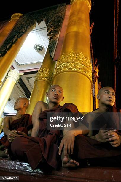 This picture taken on March 7, 2010 shows Myanmar monks resting at a shrine hall in the courtyard of the Shwedagon pagoda in Yangon. Myanmar is a...
