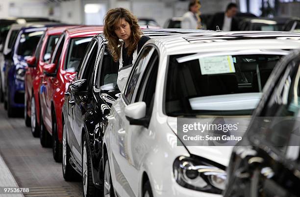 Worker inspects finsihed Volkswagen Golf cars at the end of the assembly line at the VW factory on March 8, 2010 in Wolfsburg, Germany. Volkswagen...