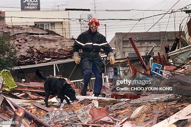 French rescue team works over the debris of a collapsed building on January 22, 1995 five days after the massive earthquake on January 17, 1995 in...