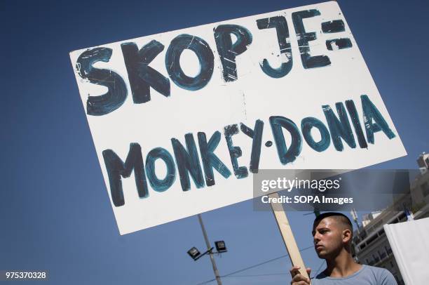 Demonstrator seen holding a placard at the demonstration. People demonstrated in Syntagma square, Athens, in protest at the Greek government's...