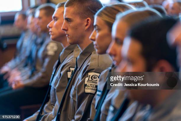 Class of graduating police academy cadets listen as U.S. Attorney General Jeff Sessions delivers remarks on immigration and law enforcement actions...
