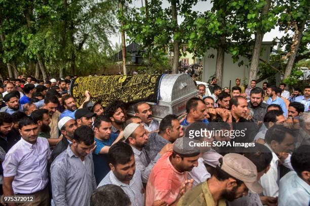 Kashmiri mourners carry the coffin of Shujaat Bukhari, veteran journalist and Editor-in-Chief of English daily 'Rising Kashmir,' in Kreeri, some...