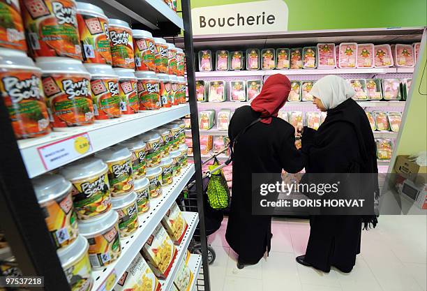 Women buy food at "Hal' shop", a supermarket selling halal food, in Nanterre, a Paris suburb, some hours after its inauguration on March 3, 2010. The...