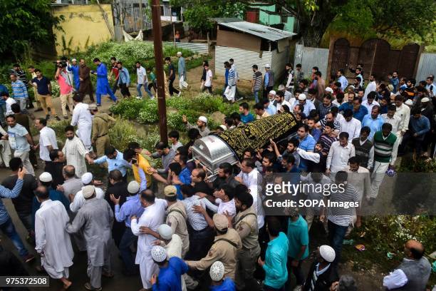 Kashmiri mourners carry the coffin of Shujaat Bukhari, veteran journalist and Editor-in-Chief of English daily 'Rising Kashmir,' in Kreeri, some...