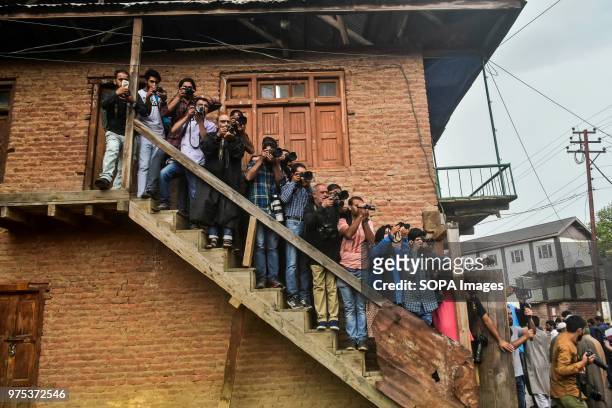 Kashmiri journalists take pictures during a funeral procession for Shujaat Bukhari, veteran journalist and Editor-in-Chief of English daily 'Rising...