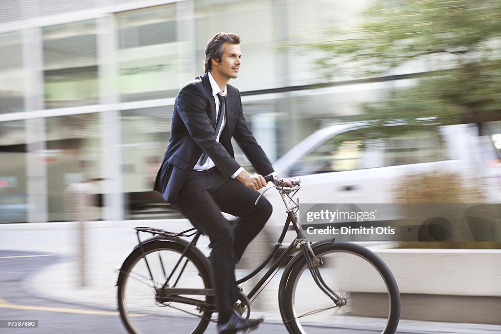 Smartly dressed man riding a bicycle