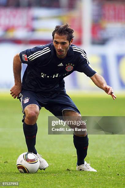 Hamit Altintop of Muenchen runs with the ball during the Bundesliga match between 1. FC Koeln and FC Bayern Muenchen at RheinEnergieStadion on March...