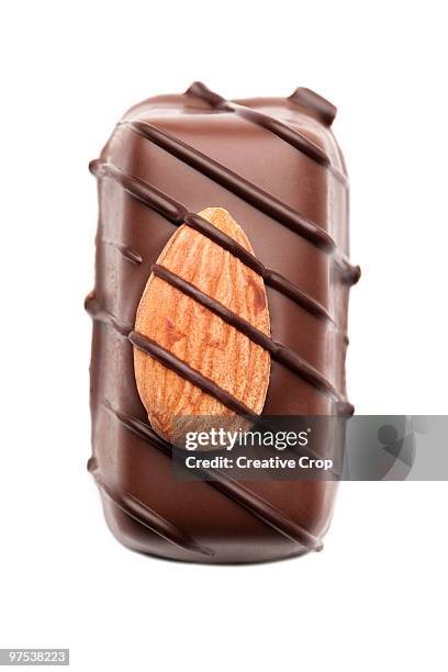 single chocolate with almond on-top - creative rf stock-fotos und bilder