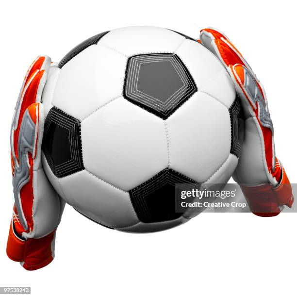 two goal keepers gloves holding a football - creative rf stock pictures, royalty-free photos & images