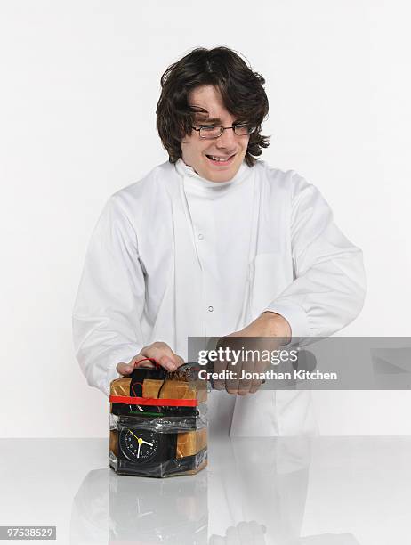 scientist defuses a bomb carefully - table bomb stock pictures, royalty-free photos & images