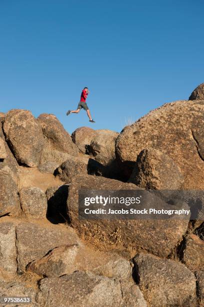 Leap Over Rocks 48 Man Jumping Over Rock Ledge Stock Photos, High-Res Pictures, and ...