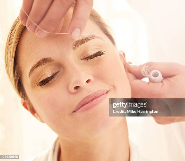 eyebrow threading - threading stock pictures, royalty-free photos & images