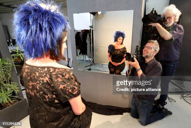 Dpatop - 16 May 2018, Germany, Rostock: Angret Kristens looking at herself in the mirror after her transformation to 'Lady in Blue' whilst being...