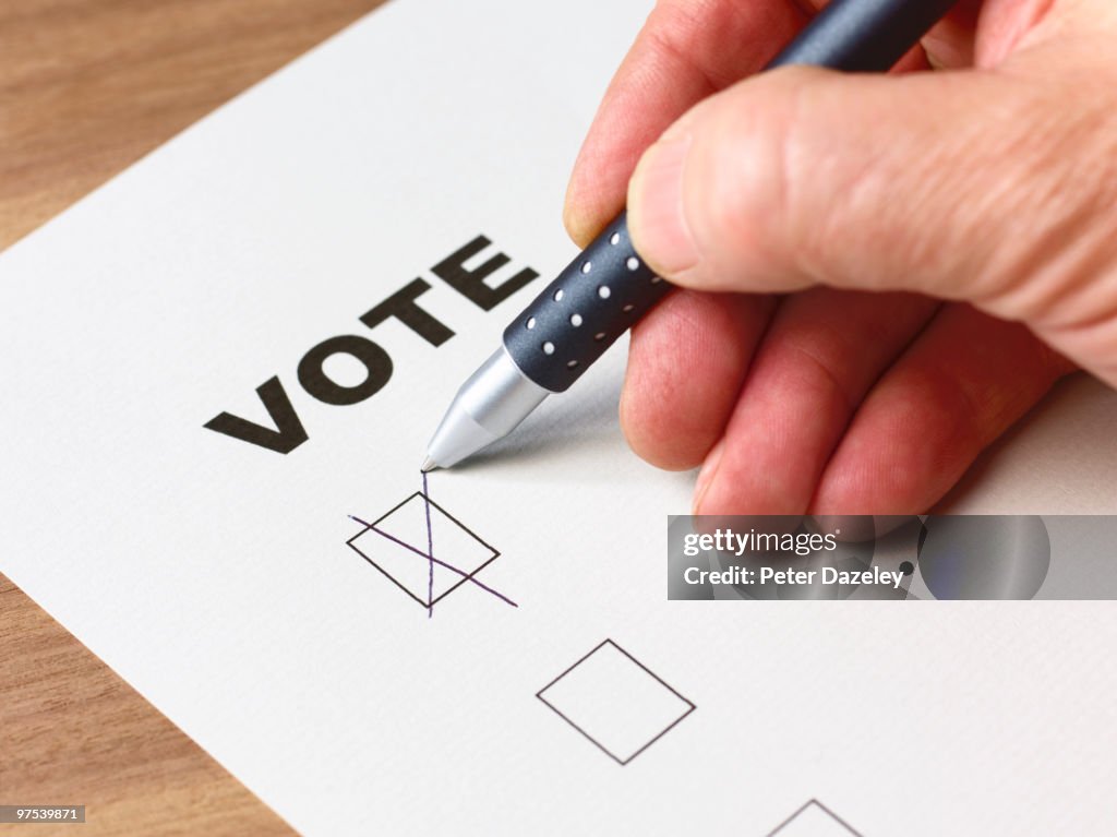 Senior man voting with cross