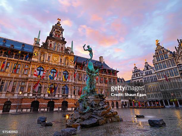 brabo fountain & city hall at dusk - belgien stock-fotos und bilder