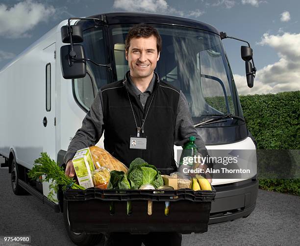 delivery driver with basket of food. - supermarket delivery stock pictures, royalty-free photos & images