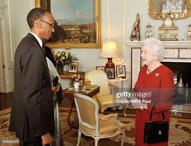 Queen Elizabeth II talks with Rwanda's President Paul Kagame after he arrived at Buckingham Palace at Buckingham Palace for a private audience on...