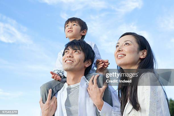 two parents with son looking up, low angle view - looking up ストックフォトと画像