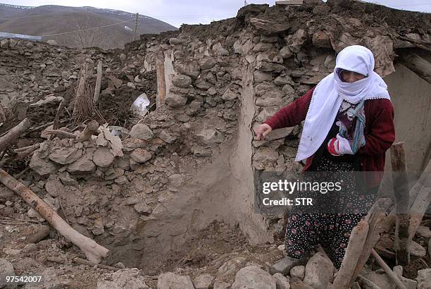 Woman stands in front of her destroyed house in Karakocan, in the southeastern Elazig province, on March 8, 2010. At A powerful earthquake in eastern...