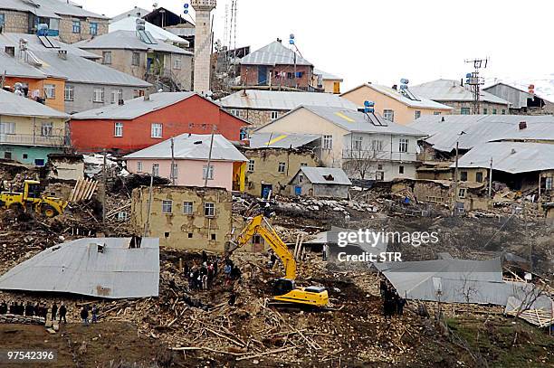 Turkish recue teams and villagers search for bodies among the ruins in the village of Okcular in Elazig province on March 8, 2010. At least 57 people...