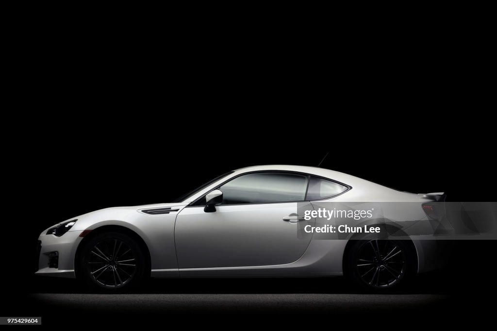 White Subaru car on a black background