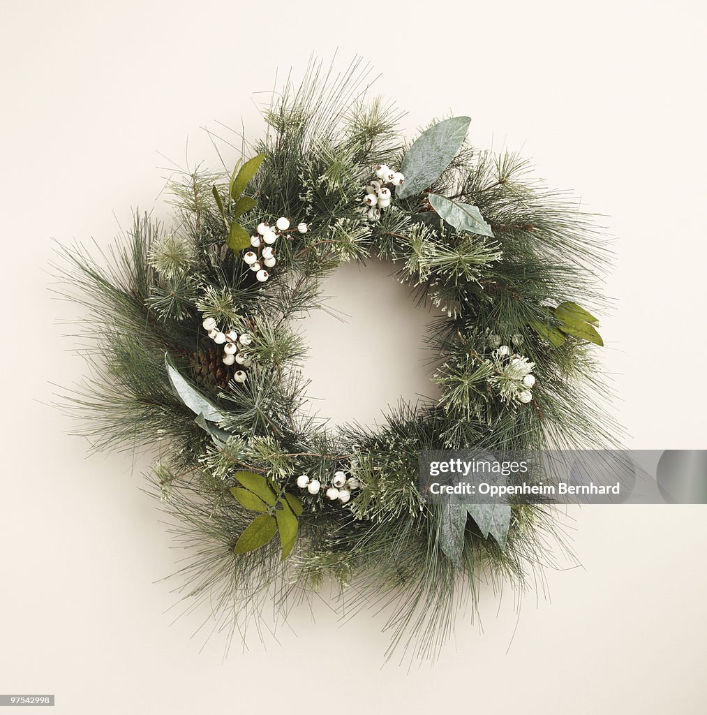 Circular christmas wreath on plain background
