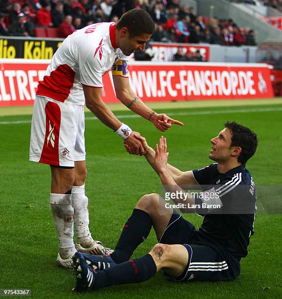 Youssef Mohamad of Koeln gestures with MArk van Bommel of Muenchen during the Bundesliga match between 1. FC Koeln and FC Bayern Muenchen at...