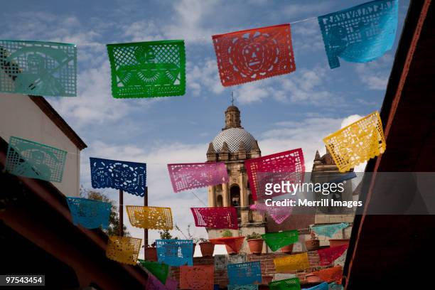 colorful tissue flags fly near cathedral - oaxaca stock pictures, royalty-free photos & images